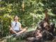 Man meditating outdoors in nature.