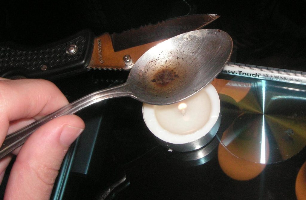 heroin in a spoon over a candle